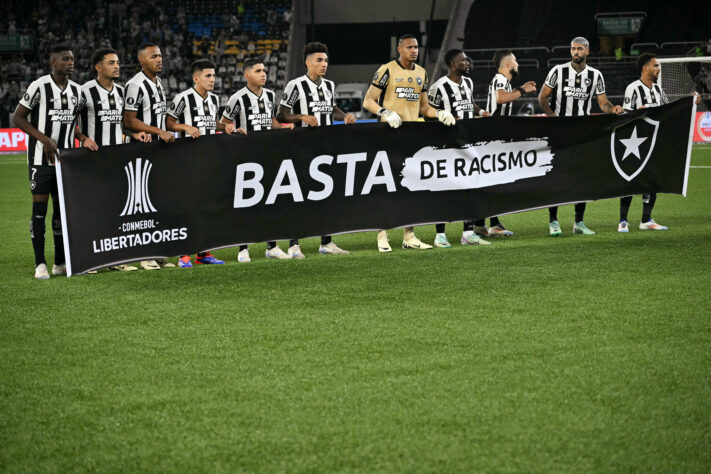 Jogadores do Botafogo entram com uma faixa contra o racismo